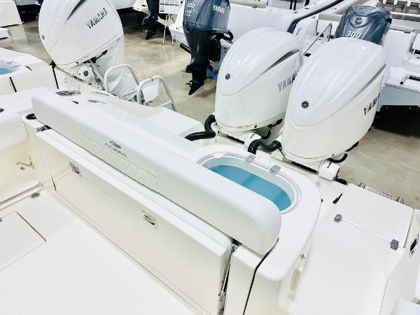 Slide: The Image of 2024 Cobia 262 CC boat with dual Yamaha engines and spacious deck layout. - 3