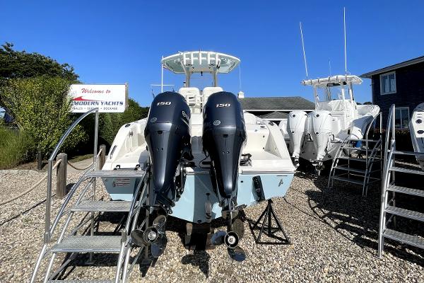 Slide: The Image of 2024 Cobia 262cc boat with twin 150 horsepower engines at Modern Yachts dealership. - 3