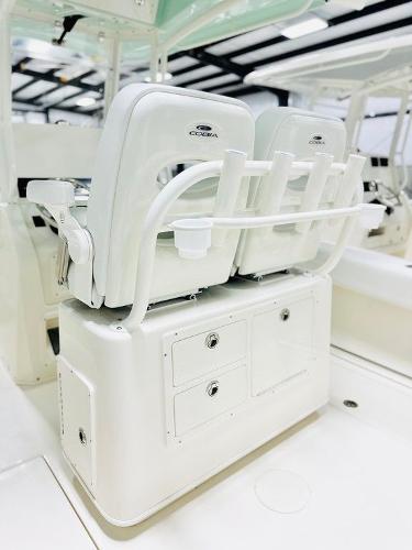 Slide: The Image of 2024 Cobia 262 CC boat seating with storage and rod holders. - 4