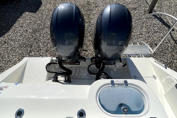 Slide: The Image of 2024 Cobia 262cc boat with dual outboard motors and livewell. - 5