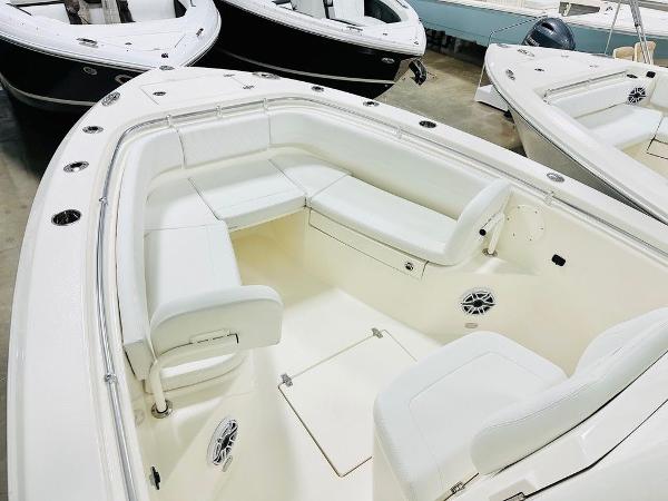 Slide: The Image of 2024 Cobia 262 CC boat interior with white seating and spacious layout. - 6