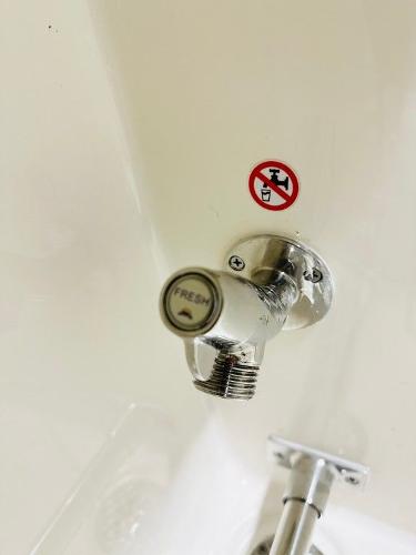 Slide: The Image of 2024 Cobia 262 CC boat fresh water outlet with no smoking sign. - 7