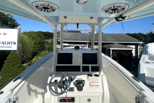 Slide: The Image of 2024 Cobia 262cc center console boat dashboard with dual screens and steering wheel. - 8