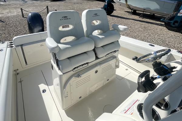 Slide: The Image of 2024 Cobia 262cc boat interior with dual captain's chairs and steering console. - 9