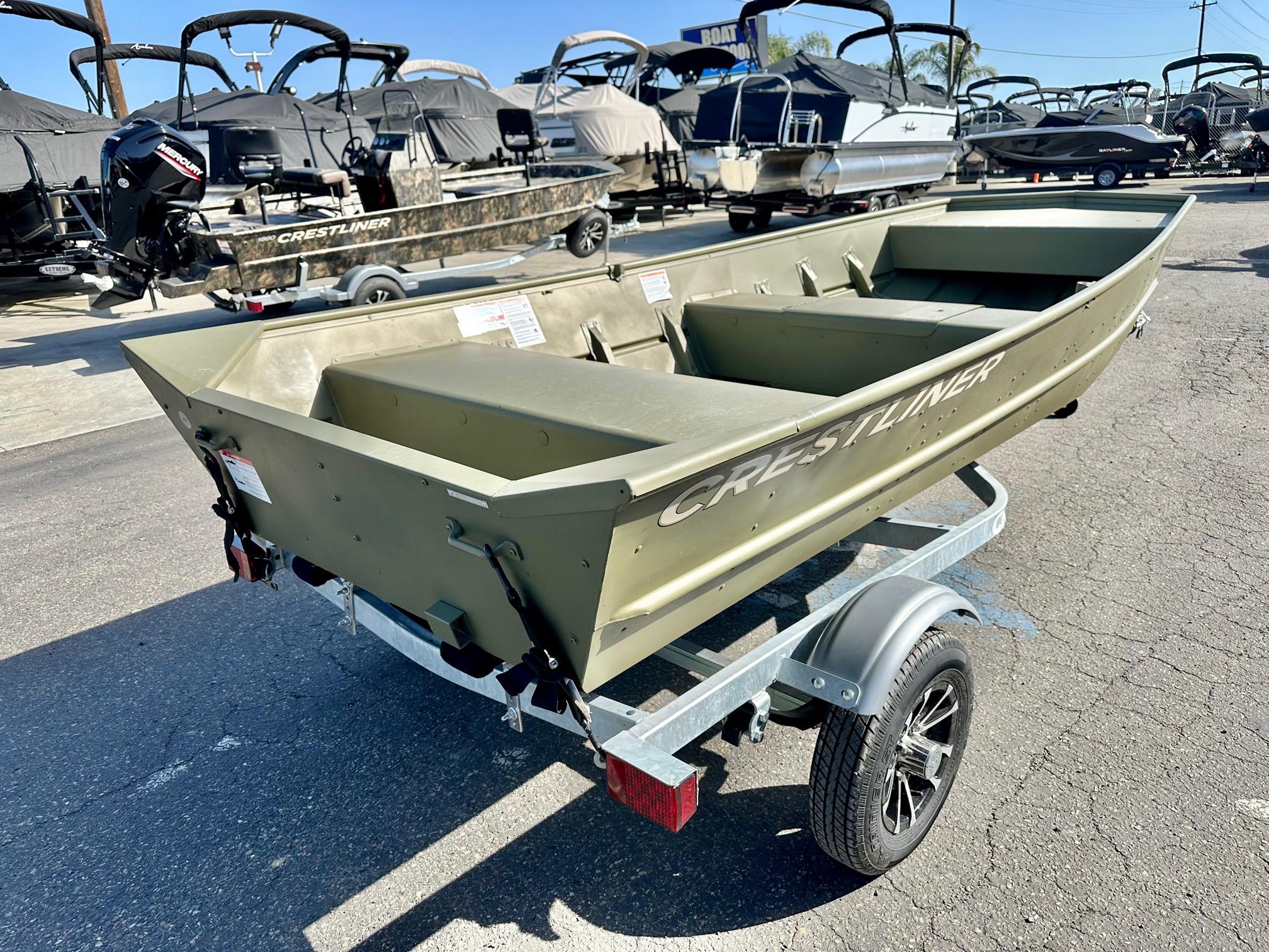 Slide: The Image of 2024 Crestliner 1448M aluminum boat on trailer at dealership. - 2