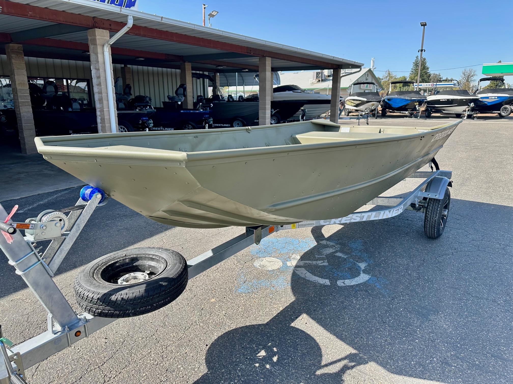 Slide: The Image of 2024 Crestliner 1448M boat on a trailer in a dealership lot. - 5