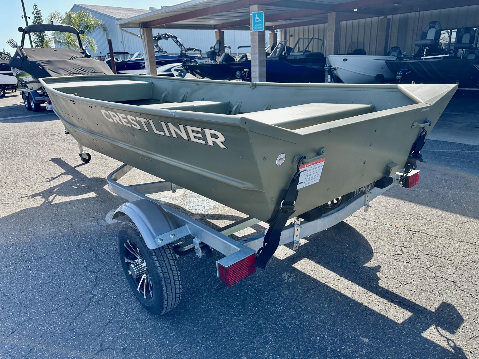 Slide: The Image of 2024 Crestliner 1448M boat on a trailer in a dealership lot. - 6