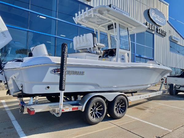 Slide: The Image of 2024 Crevalle 26 HCO boat on a trailer outside a boat sales showroom. - 1