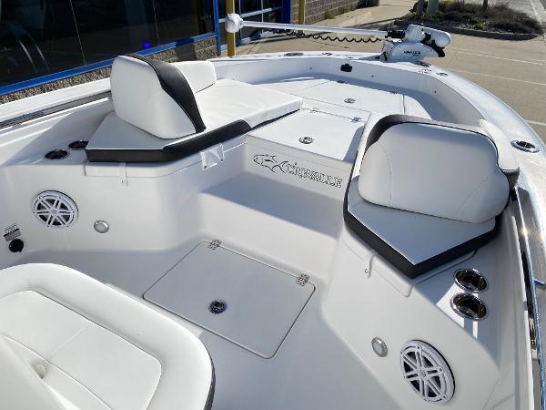 Slide: The Image of 2024 Crevalle 26 HCO boat interior with white seating and storage compartments. - 11