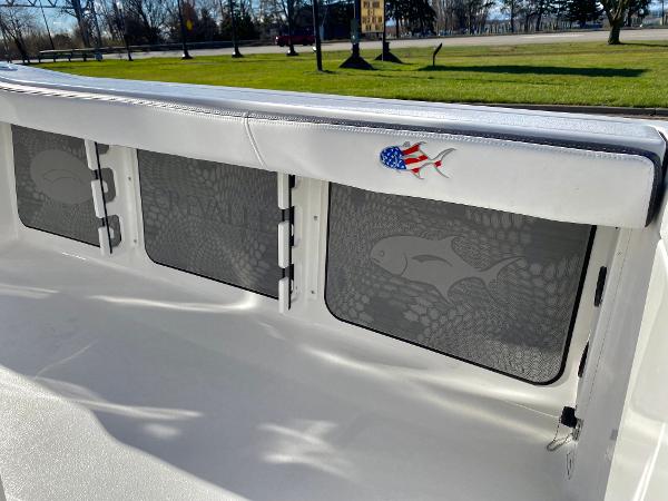 Slide: The Image of 2024 Crevalle 26 HCO boat interior with storage compartments and American flag decal. - 12