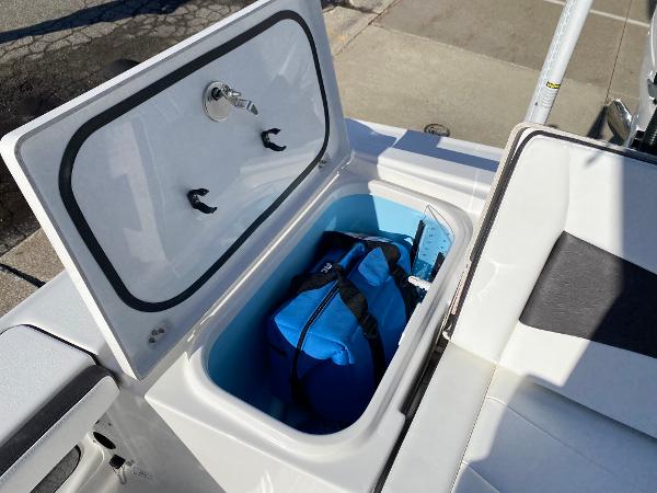 Slide: The Image of 2024 Crevalle 26 HCO storage compartment with blue bag inside. - 14