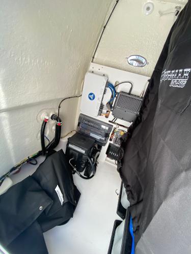 Slide: The Image of 2024 Crevalle 26 HCO boat interior with electronic equipment and wiring. - 15