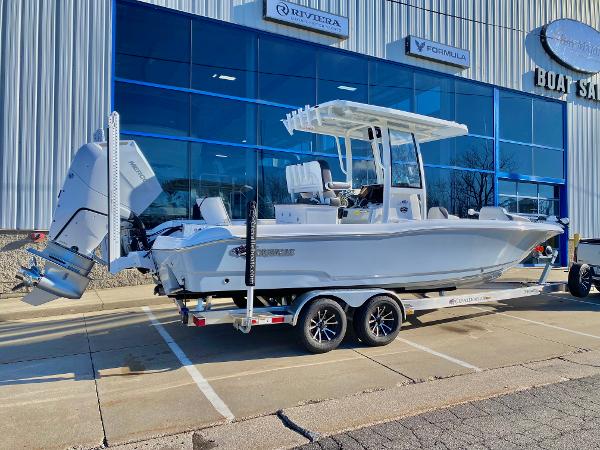 Slide: The Image of 2024 Crevalle 26 HCO boat on trailer outside dealership. - 2