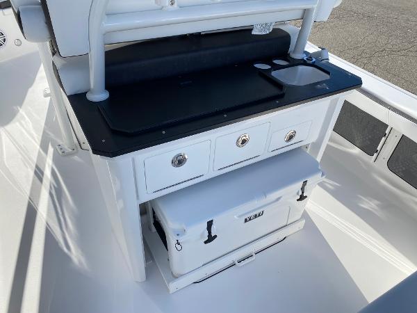 Slide: The Image of 2024 Crevalle 26 HCO boat console with storage drawers and Yeti cooler. - 4
