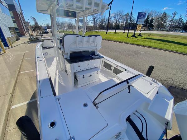 Slide: The Image of 2024 Crevalle 26 HCO boat, docked, showcasing spacious deck and seating area. - 5