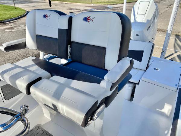 Slide: The Image of 2024 Crevalle 26 HCO boat with dual captain's chairs and outboard motor. - 7