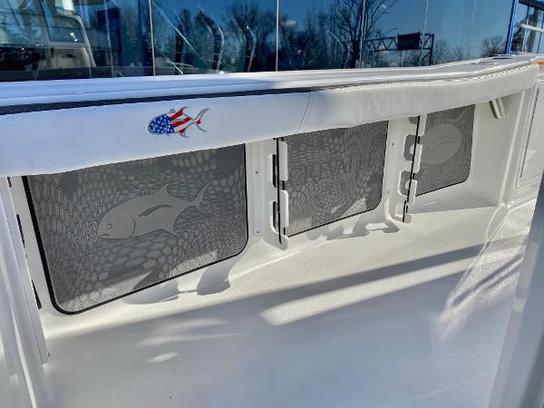 Slide: The Image of 2024 Crevalle 26 HCO boat interior with fish-themed storage compartments. - 8