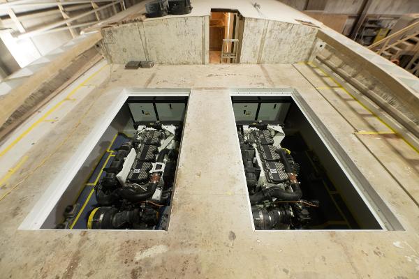 Slide: The Image of 2024 Custom Carolina 63 boat under construction, showcasing dual engine compartments. - 13