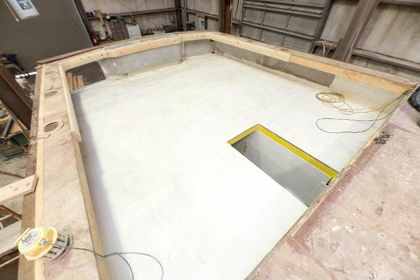 Slide: The Image of 2024 Custom Carolina 63 boat under construction in a workshop. - 15