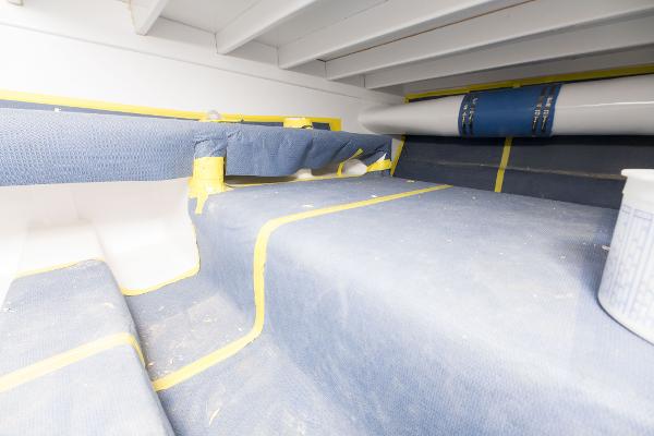 Slide: The Image of Interior construction of 2024 Custom Carolina 63 boat with protective coverings. - 19
