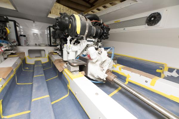 Slide: The Image of Engine room of 2024 Custom Carolina 63 boat with visible machinery and components. - 20