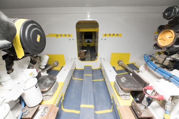 Slide: The Image of Engine room of a 2024 Custom Carolina 63 boat with visible machinery. - 30