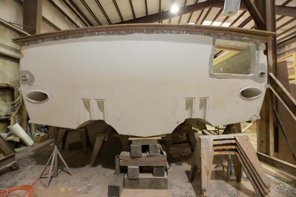 Slide: The Image of Custom Carolina 63 boat under construction in a workshop, 2024 model. - 5