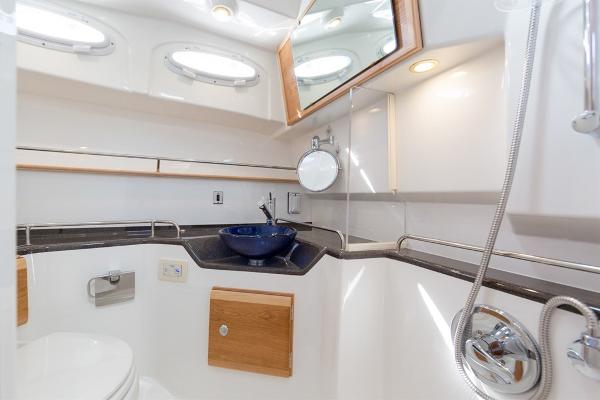 Slide: The Image of Modern bathroom in 2024 Cutwater 32 CB boat with blue sink and wood accents. - 11