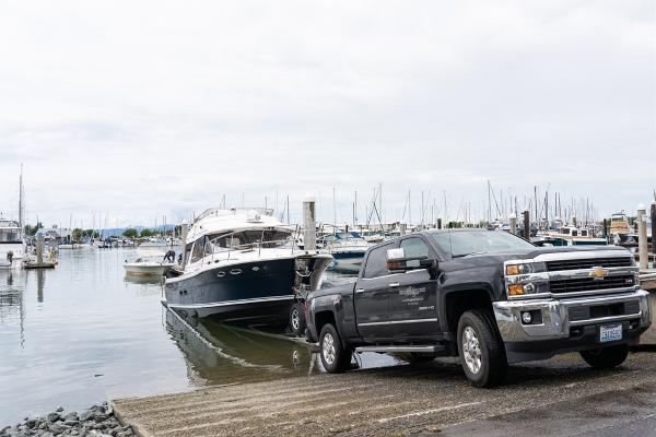 Slide: The Image of Truck launching a 2024 Cutwater 32 CB boat at a marina. - 13