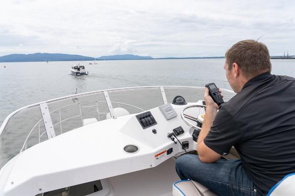 Slide: The Image of Man operating 2024 Cutwater 32 CB boat on calm waters. - 14