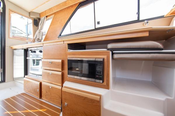 Slide: The Image of Interior of 2024 Cutwater 32 CB boat with modern kitchen amenities. - 4