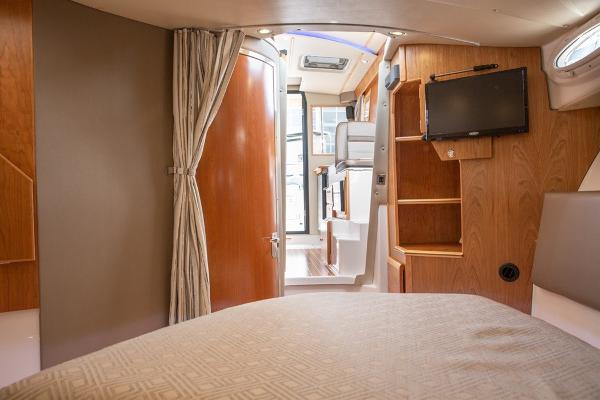 Slide: The Image of Interior cabin of 2024 Cutwater 32 CB boat with TV and wooden finishes. - 6