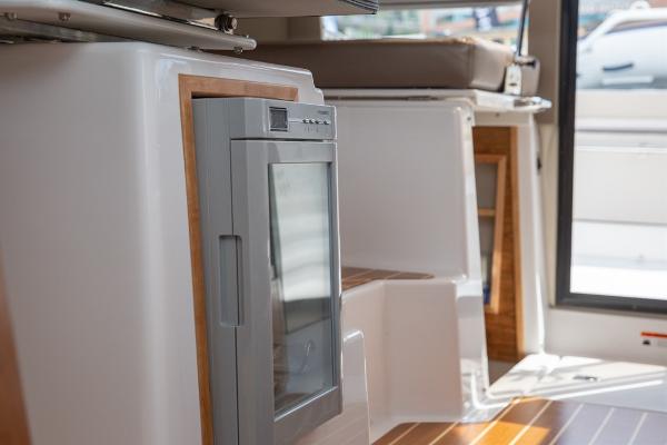 Slide: The Image of Interior of 2024 Cutwater 32 CB boat, featuring modern cabinetry and seating. - 7