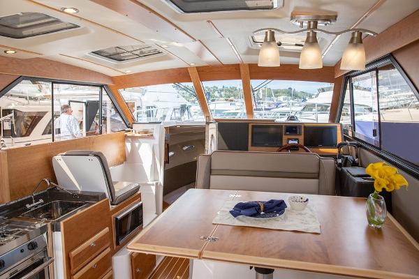 Slide: The Image of Interior of 2024 Cutwater 32 CB yacht with modern kitchen and dining area. - 9