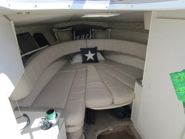 Slide: The Image of Interior cabin of a 2000 Formula 280 SS boat with beige seating and pillows. - 11