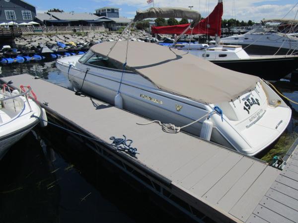 Slide: The Image of 2000 Formula 280 SS boat docked at marina with cover. - 2