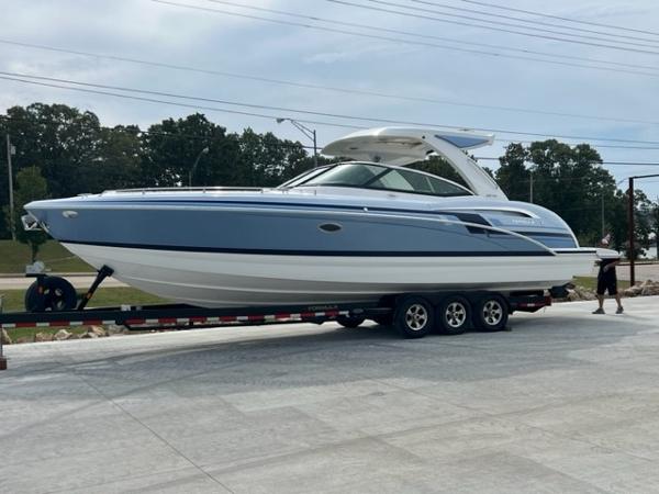 Slide: The Image of 2023 Formula 350 CBR boat on trailer, sleek design, blue and white exterior. - 0