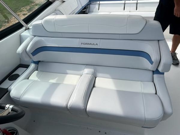 Slide: The Image of 2023 Formula 350 CBR boat interior with white and blue seating. - 10