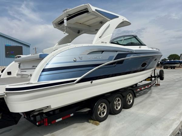 Slide: The Image of 2023 Formula 350 CBR boat on trailer, sleek design, blue and white exterior. - 2