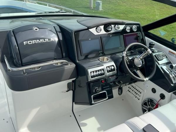Slide: The Image of 2023 Formula 350 CBR boat cockpit with modern controls and steering wheel. - 5