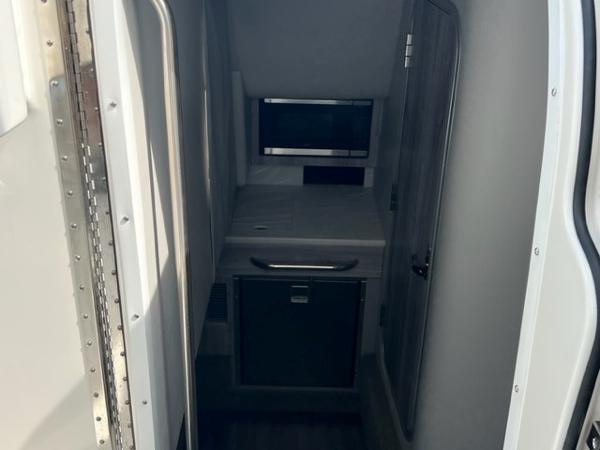 Slide: The Image of 2023 Formula 350 CBR cabin interior with compact kitchenette and storage. - 8