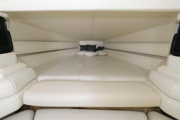 Slide: The Image of Interior cabin of 1991 Fountain 38 Sport Cruiser with white leather seating and pillows. - 12