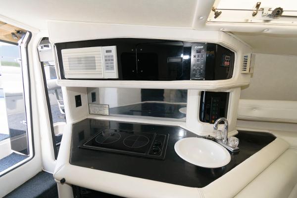 Slide: The Image of 1991 Fountain 38 Sport Cruiser kitchen with stove, microwave, and sink. - 14