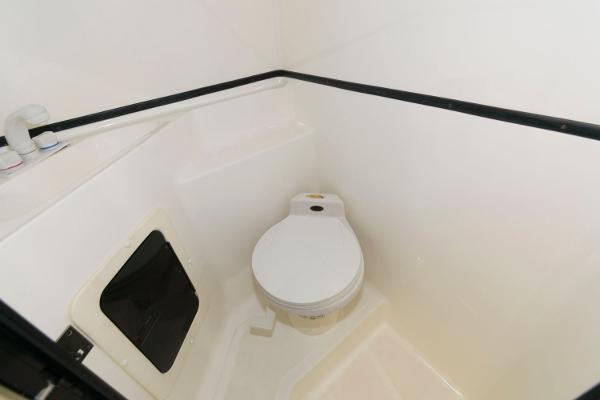 Slide: The Image of 1991 Fountain 38 Sport Cruiser bathroom with compact toilet and white interior. - 16