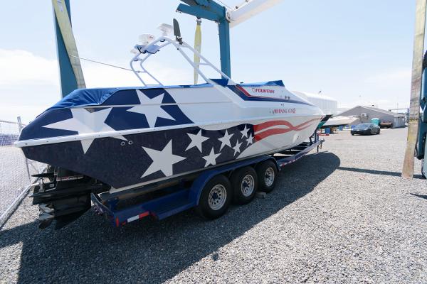 Slide: The Image of 1991 Fountain 38 Sport Cruiser with American flag design on trailer. - 2