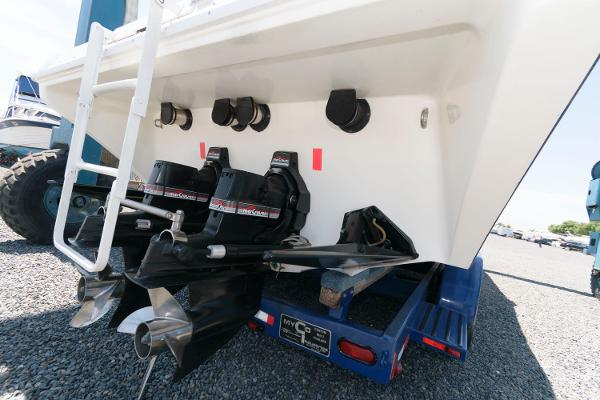 Slide: The Image of 1991 Fountain 38 Sport Cruiser boat stern with dual outboard motors on trailer. - 21