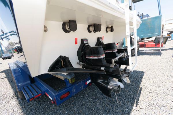 Slide: The Image of 1991 Fountain 38 Sport Cruiser boat stern with dual outboard motors on trailer. - 22