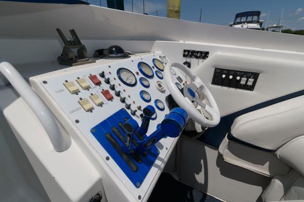 Slide: The Image of 1991 Fountain 38 Sport Cruiser helm with gauges, controls, and white steering wheel. - 6