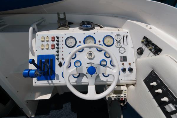 Slide: The Image of 1991 Fountain 38 Sport Cruiser dashboard with steering wheel and control panel. - 7