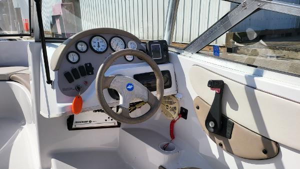 Slide: The Image of 1996 Four Winns 190 Horizon Bowrider boat dashboard with steering wheel and control panel. - 10